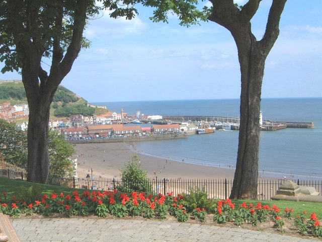 A view towards the headland from the town, the Castle ruins are hidden behind the tree on the left.